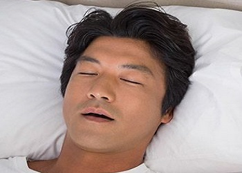 Man in bed snoring