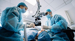 Oral surgeon performing dental implant surgery