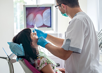 Dentist and dental patient looking at intraoral images