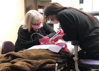 Dentist and team member treating dental patient