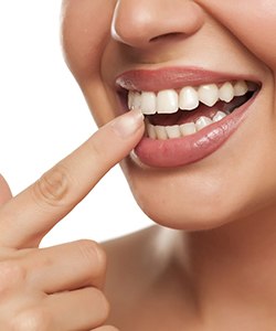 A woman pointing at her teeth