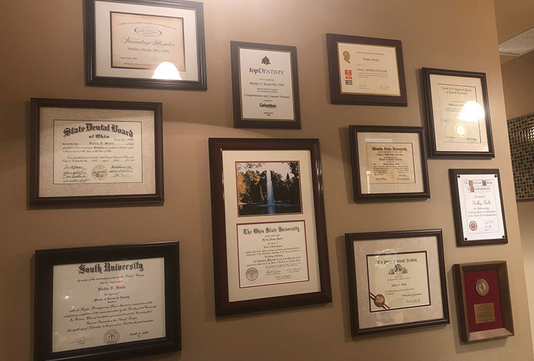 Certificates and degrees on dental office wall