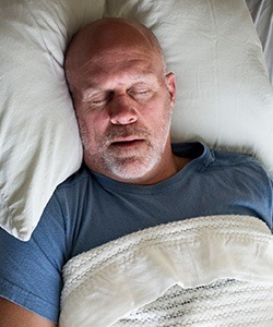 Man sleeping soundly in bed