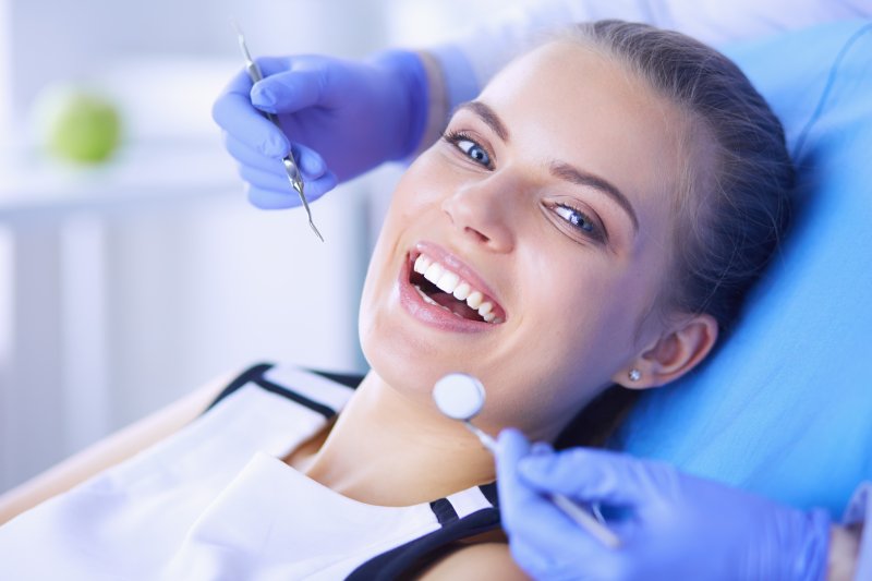 A woman having her teeth cleaned at the dentist’s office