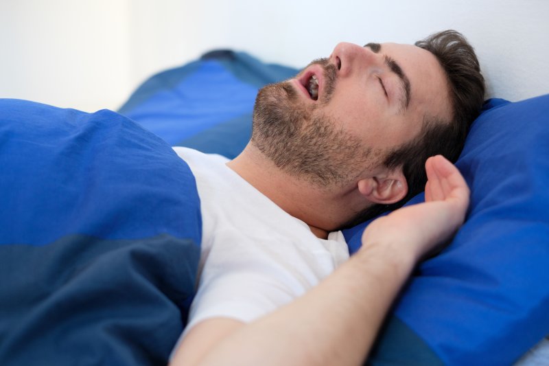 middle-aged man asleep with his mouth open and snoring